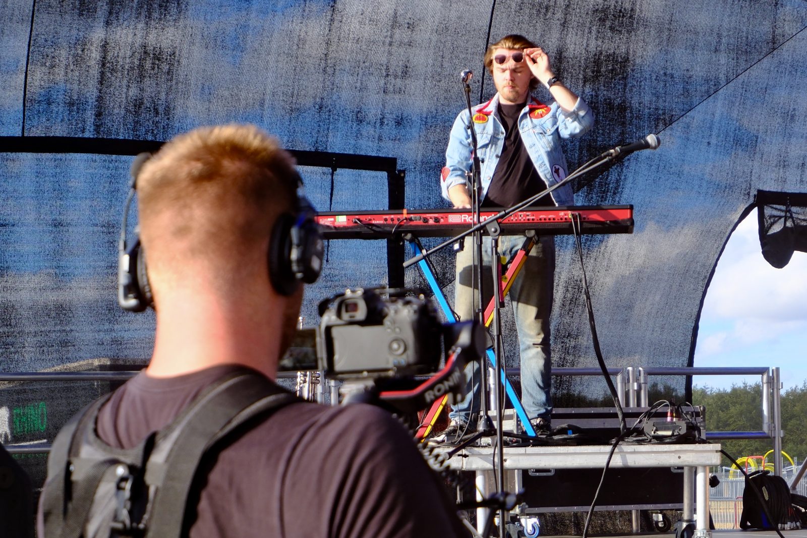 dwmedia camera operator filming a keyboard player on stage at the British Airways Fly-In