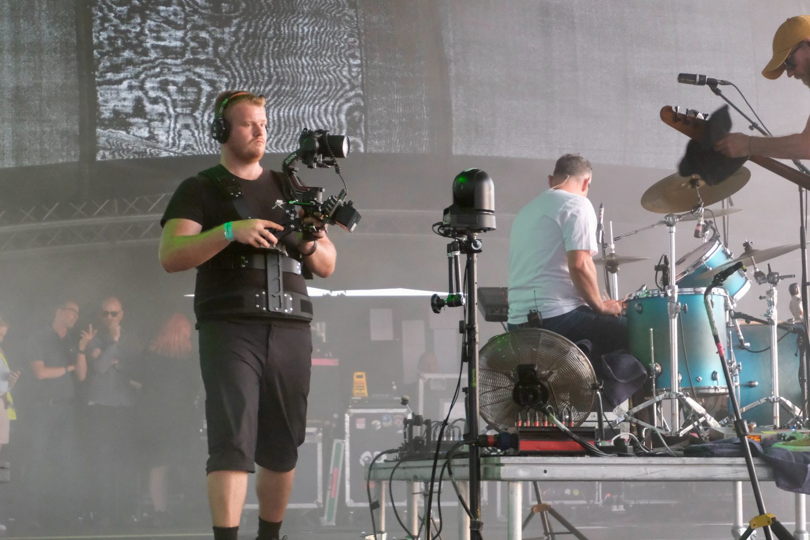 dwmedia operator with a Ronin gimbal on stage beside the drummer at the British Airways Fly-In