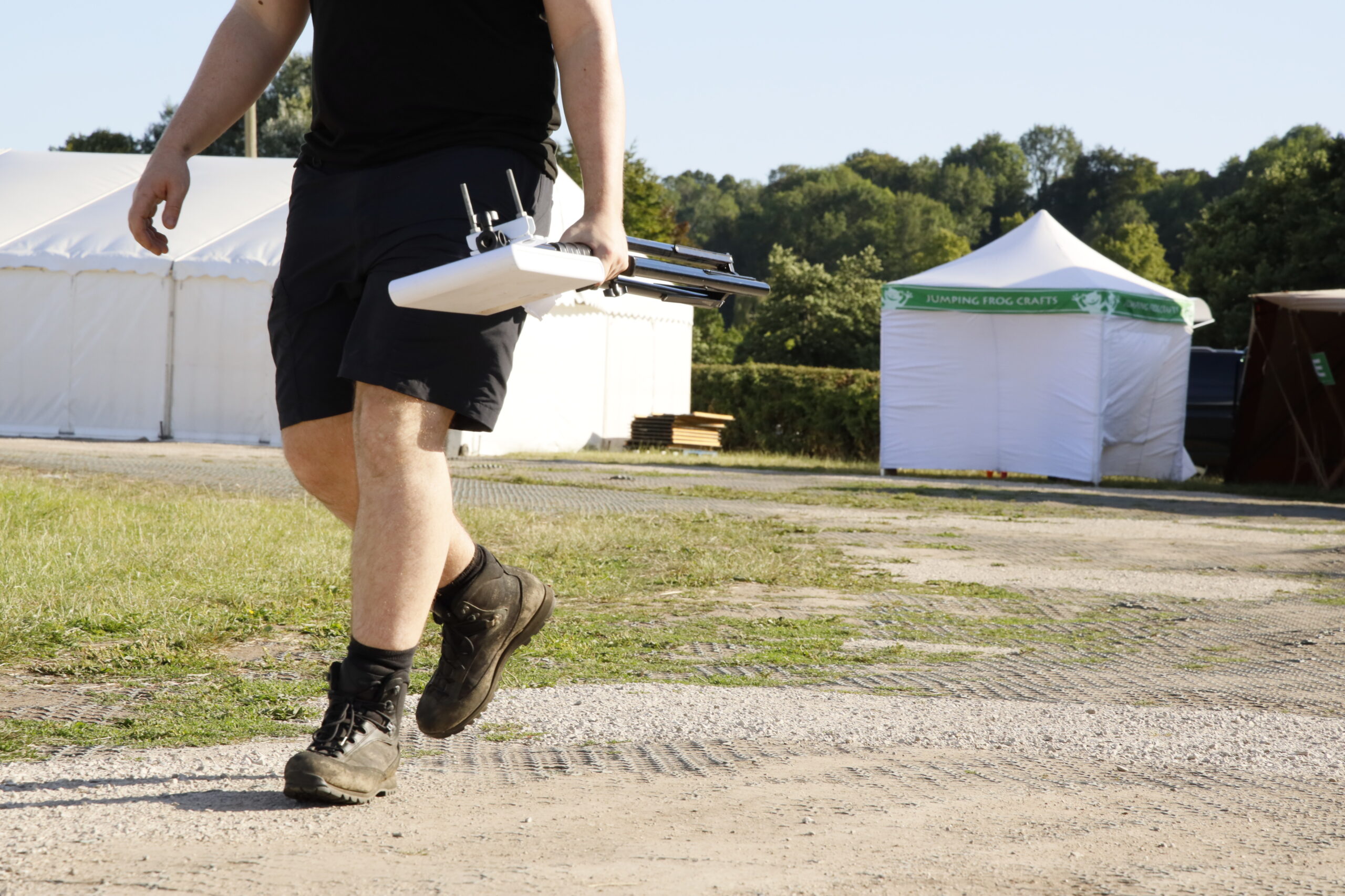 Access point on a tripod being carried across a site during a survey